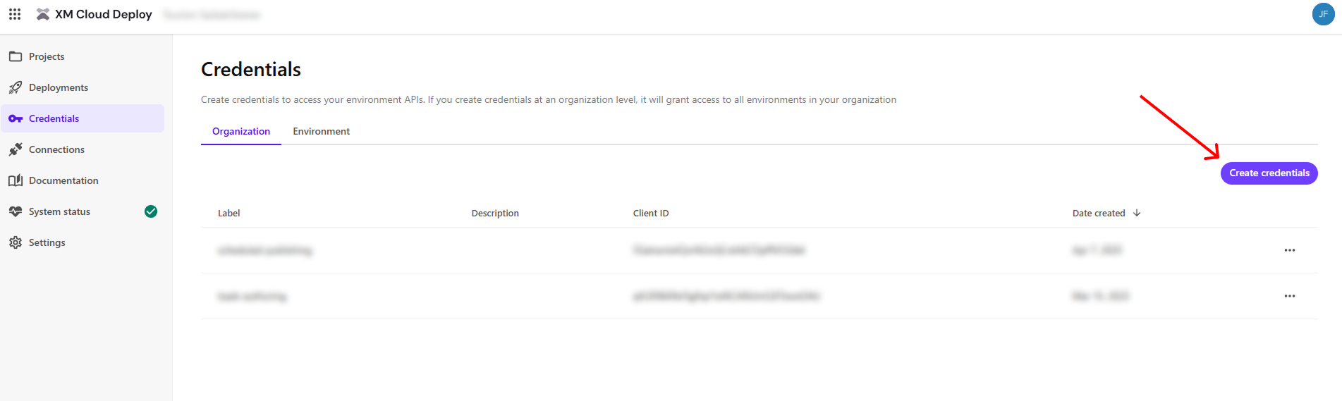Sitecore XM Cloud Deploy credentials screen with a red arrow pointing to the 'Create credentials' button